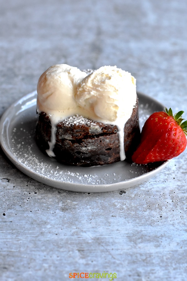 Chocolate cake topped with ice cream scoops
