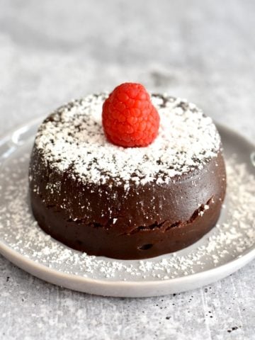 Chocolate cake topped with raspberry and powder sugar