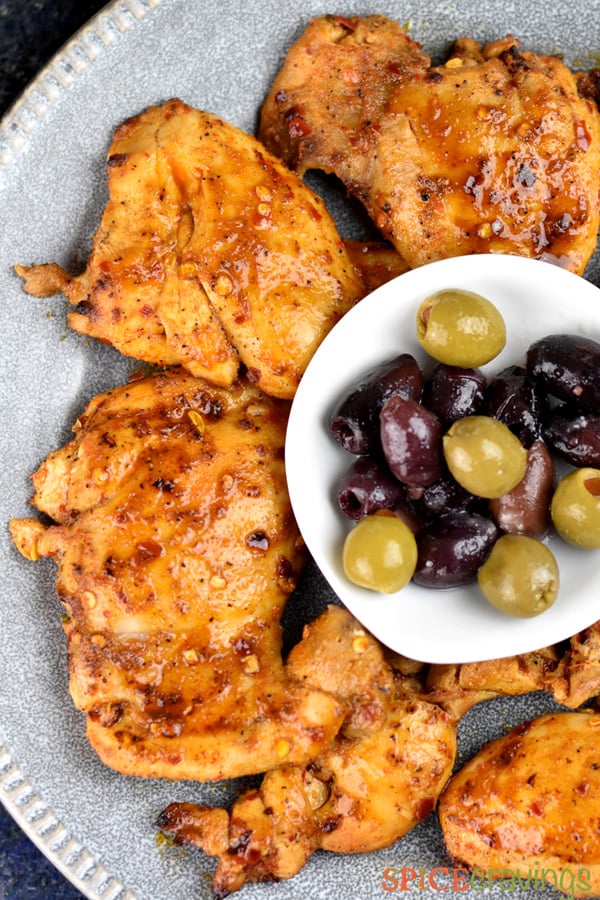 Grilled mediterranean chicken plated with mixed olives