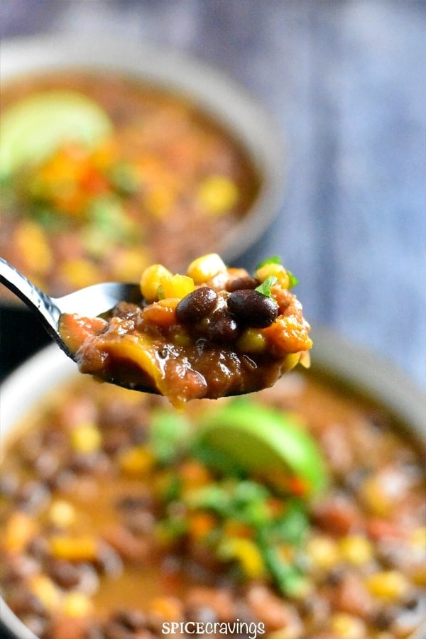A spoonful of black bean chili with corn and peppers