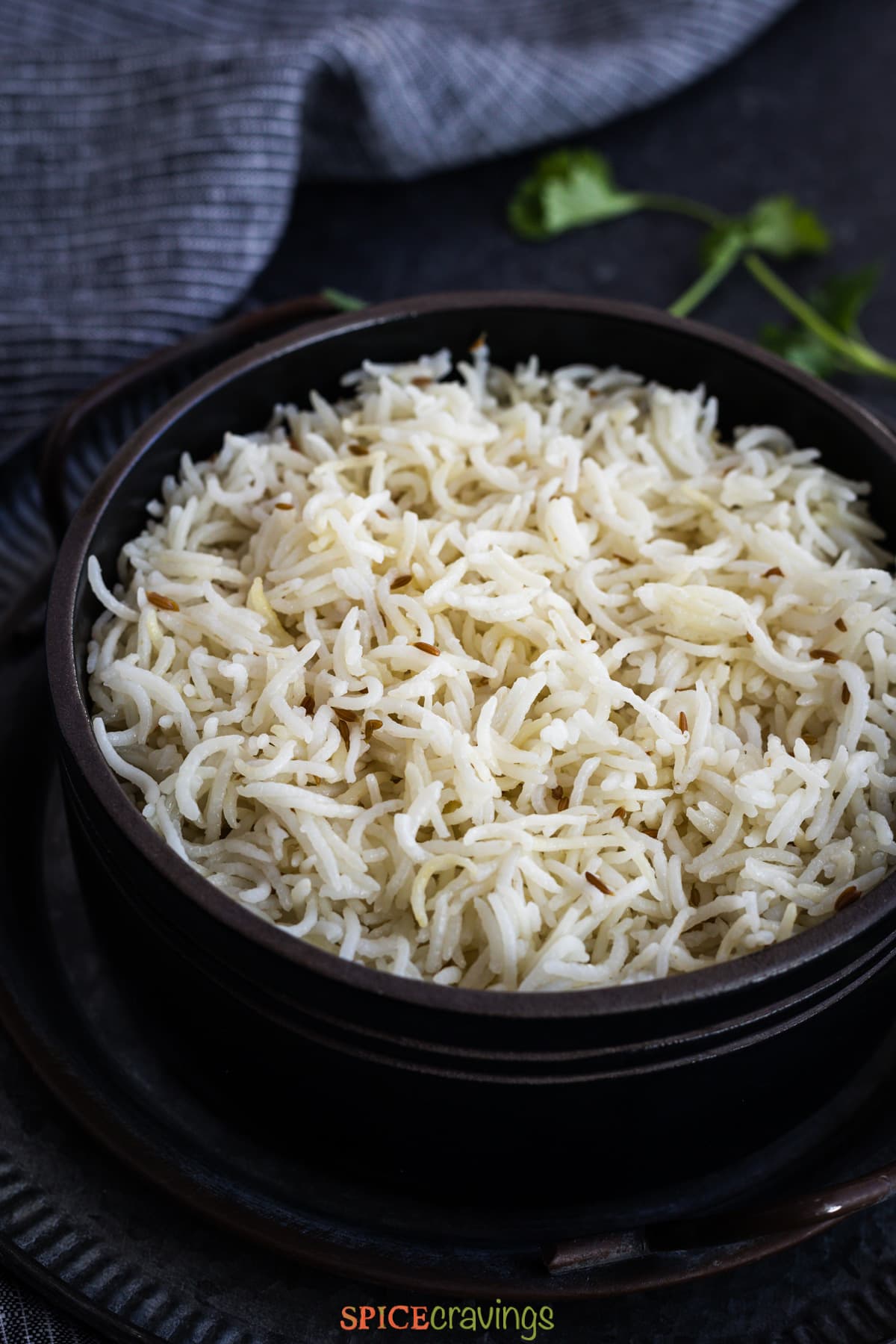 black bowl filled with jeera rice instant pot