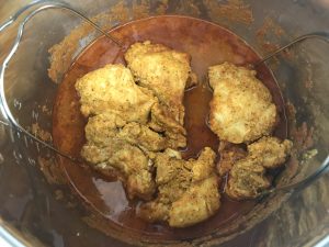 Chicken cooked on a trivet in the Instant Pot for Authentic Butter Chicken
