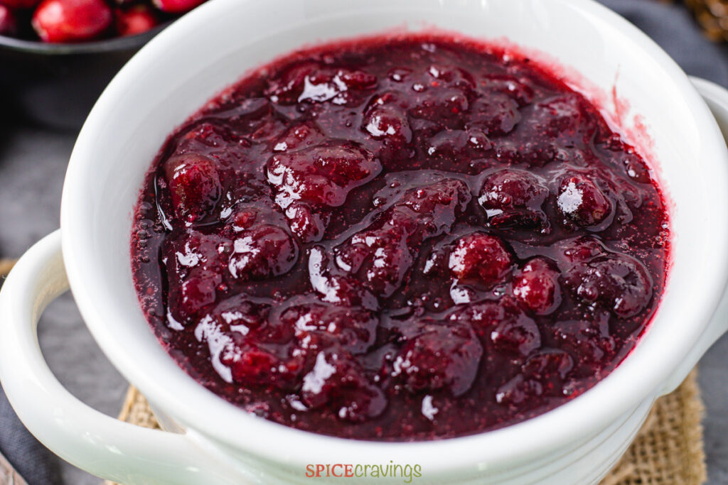 Cranberry Sauce Instant Pot by Spice Cravings. Cranberry sauce is a jam like relish made by cooking cranberries with sugar. A popular accompaniment served with Turkey at Thanksgiving & Christmas dinner. #food #foodie #foodblogger #delicious #recipe #instantpot #recipes #easyrecipe #cuisine #30minutemeal #instagood #foodphotography #tasty 
