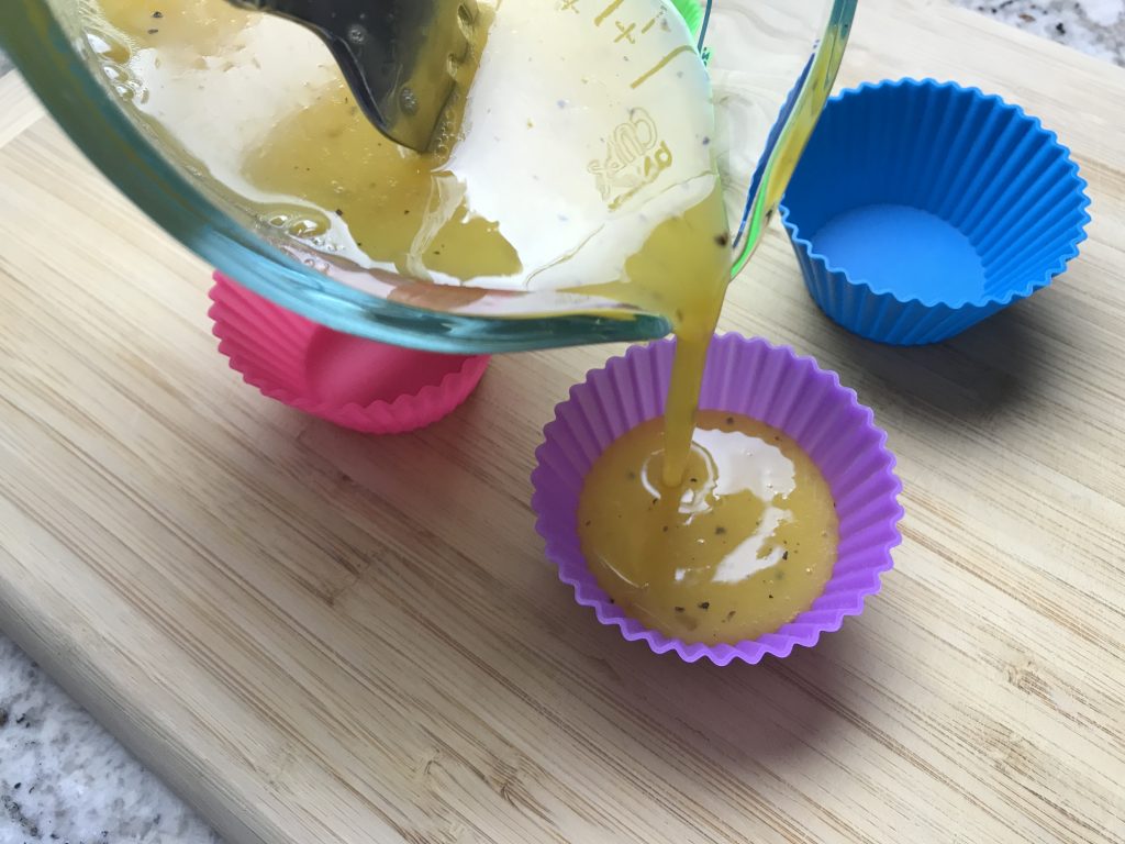 Pouring the egg mixture in the silicone cupcake mold for making egg bites