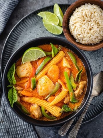 Thai panang curry served with brown jasmine rice in a grey bowl