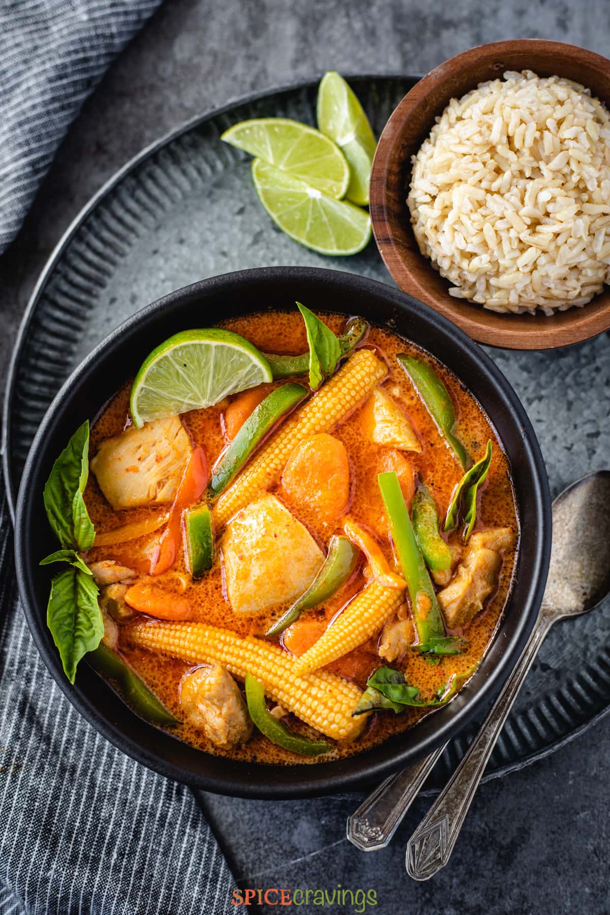 Thai panang curry served with brown jasmine rice in a black bowl