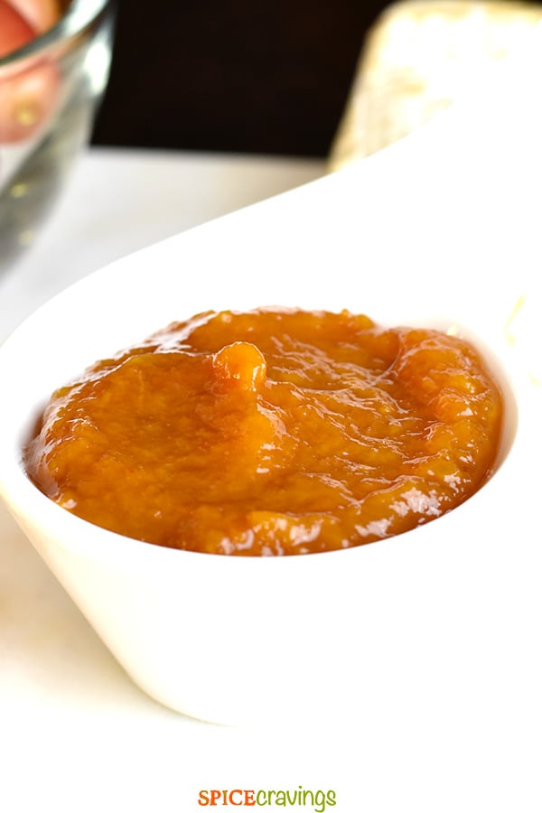 Peach chutney served in a white bowl