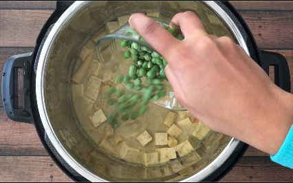 Adding peas to the curry