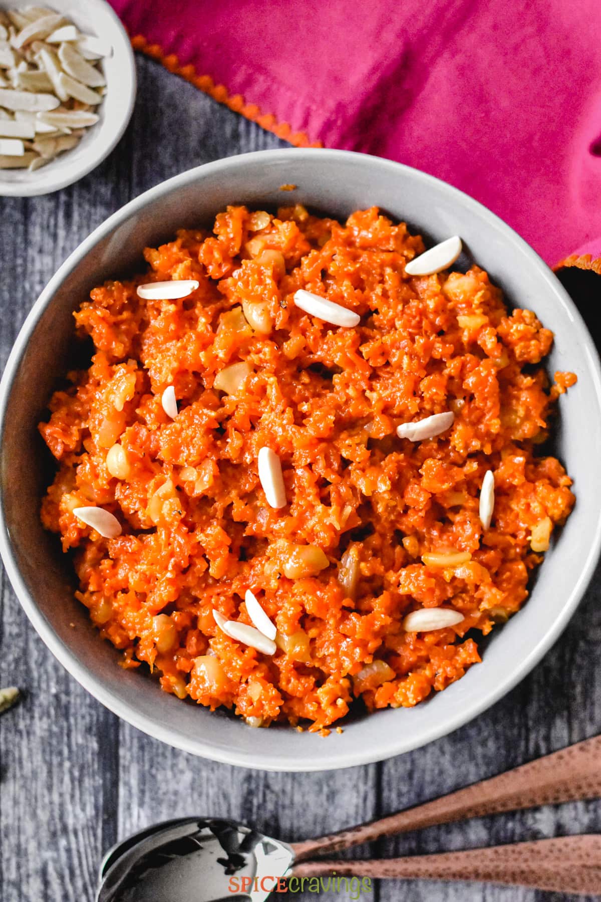Indian carrot halwa in grey bowl garnished with slivered almonds