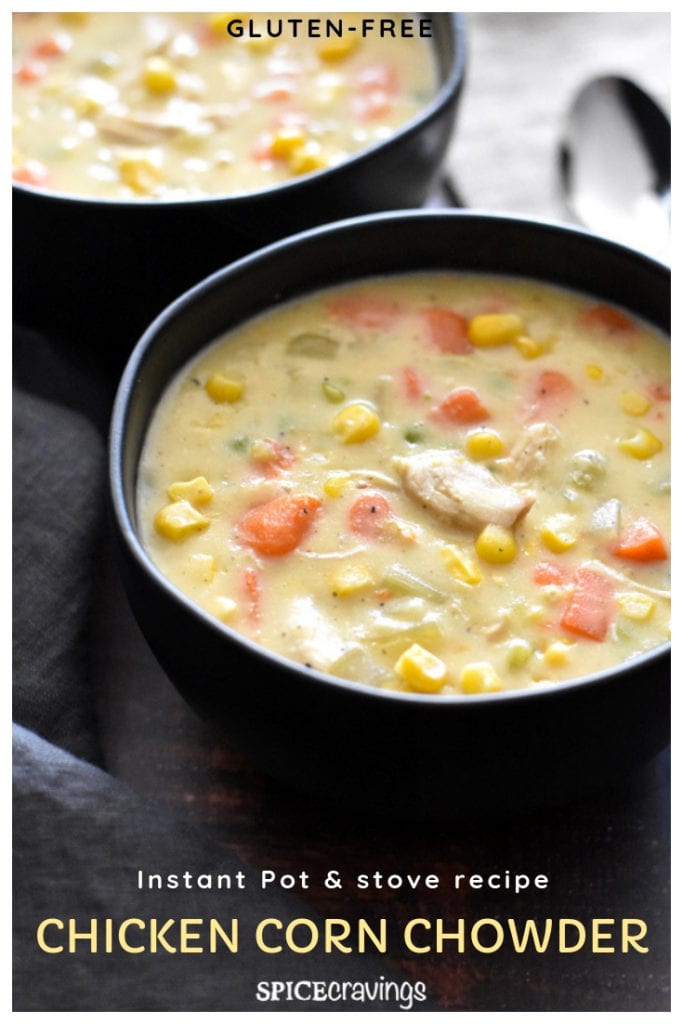 Thick chicken corn chowder with carrots and celery in a black bowl