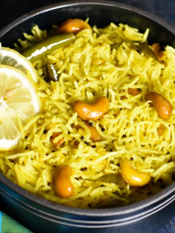 Bowl of lemon rice with mustard , garnished with lime slices