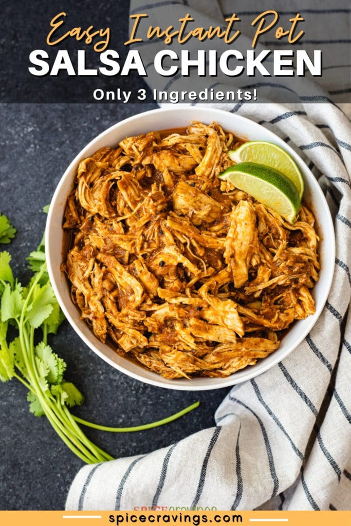 Bowl of shredded chicken with salsa with lime wedges