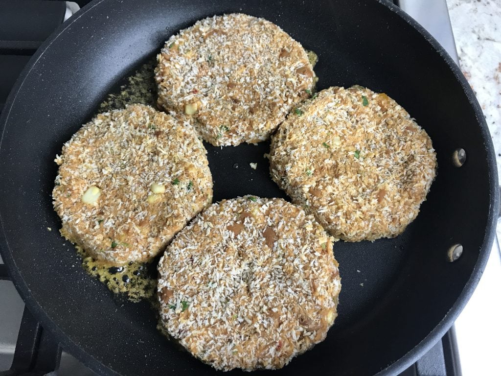 Bean burger patties placed in a skillet for cooking