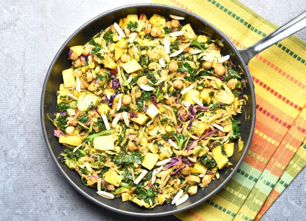Kale mango slaw with chickpeas, made by sauteing kale slaw mix (from Trader Joeâ€™s), with chickpeas, juicy mango, and topped with crunchy slivered almonds. by Spice Cravings. #cooking #food #recipe #recipes #foodphotography #foodblogger #yummy #delicious #foodie