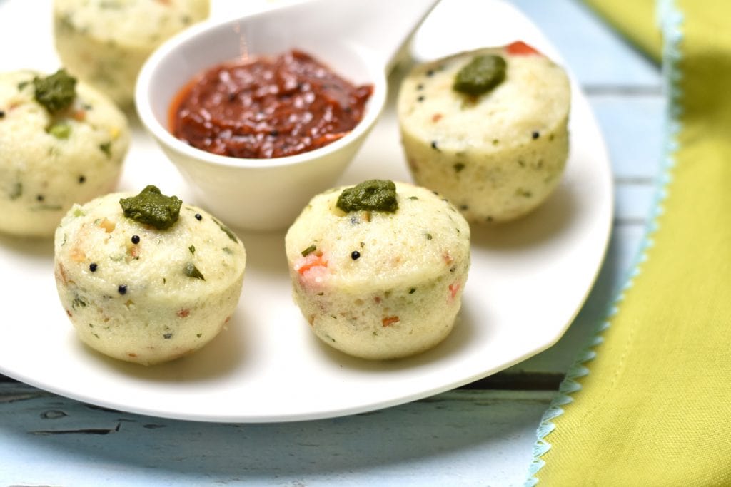 Soft & spongy Rava Idli (Steamed Semolina Cake), is a favorite with my kids. It's a variation of the popular south-Indian breakfast called 'Idli' (steamed rice & lentil cakes). Made with semolina (rava), corn, peas, carrots, and cashews, these savory cakes make for a healthy & tasty breakfast or brunch . #cooking #food #recipe #recipes #foodphotography #foodblogger #yummy #delicious #foodie #indian #breakfast #brunch