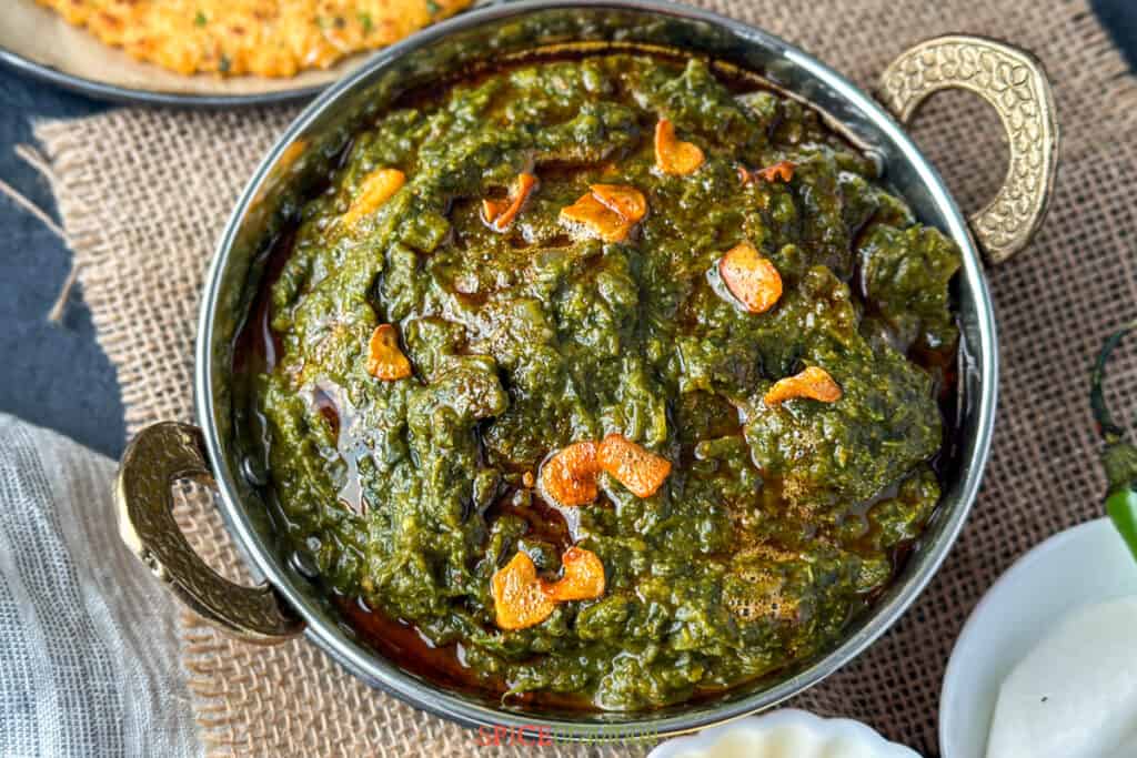 Sarson ka Saag, Indian spiced Mustard Greens by Spice Cravings. Sarson ka Saag is a leafy-vegetable preparation from Punjab, in the north of India. Traditionally a winter-time speciality, it is prepared with mustard greens & spinach, seasoned with onions, ginger, garlic, & warm Indian spices. It is usually served with makki ki roti, which is a cornmeal flatbread. #cooking #food #recipe #recipes #foodphotography #foodblogger #yummy #delicious #foodie