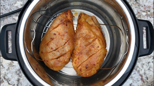 Marinated Chicken breast placed on a trivet in the Instant Pot