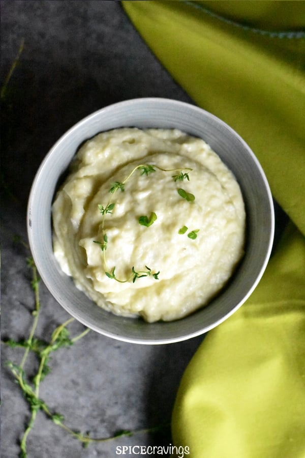A bowl of garlic cauliflower mashed potatoes served with a lime green napkin