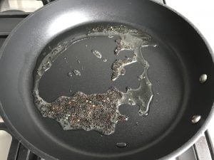 coconut oil and black mustard seeds in nonstick skillet