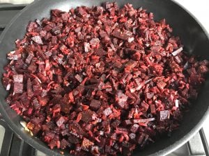 stir fried diced beets and coconut in nonstick skillet