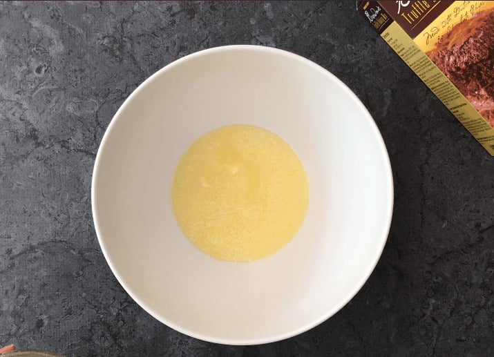 Melted butter in a large mixing bowl.