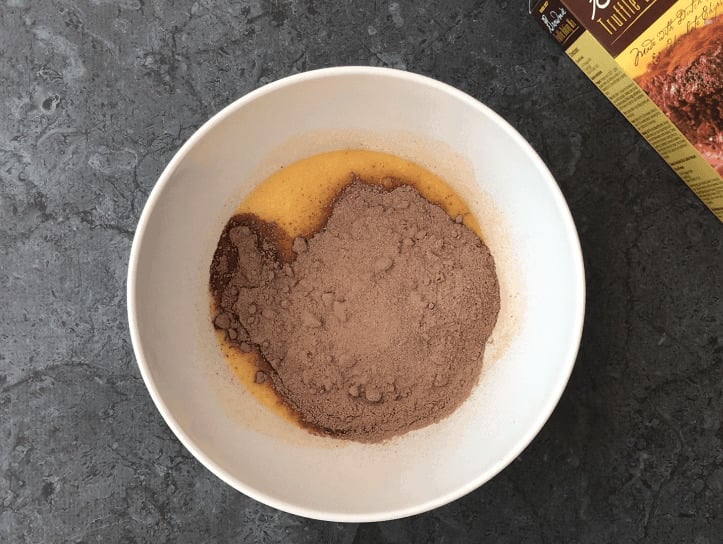 Adding brownie mix to the butter and eggs mixture