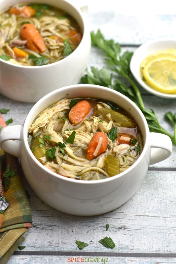 A bowl of noodles, carrots and celery in Chicken Noodle Soup