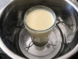 A jar of condensed milk, ready for pressure cooking