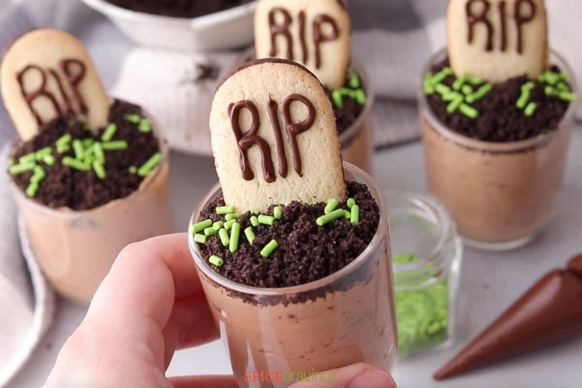 Chocolate mousse glasses topped with cookie gravestone