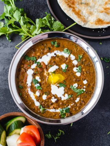 Instant pot dal makhani served with naan and rice