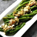 Instant Pot green beans almondine served on a white tray