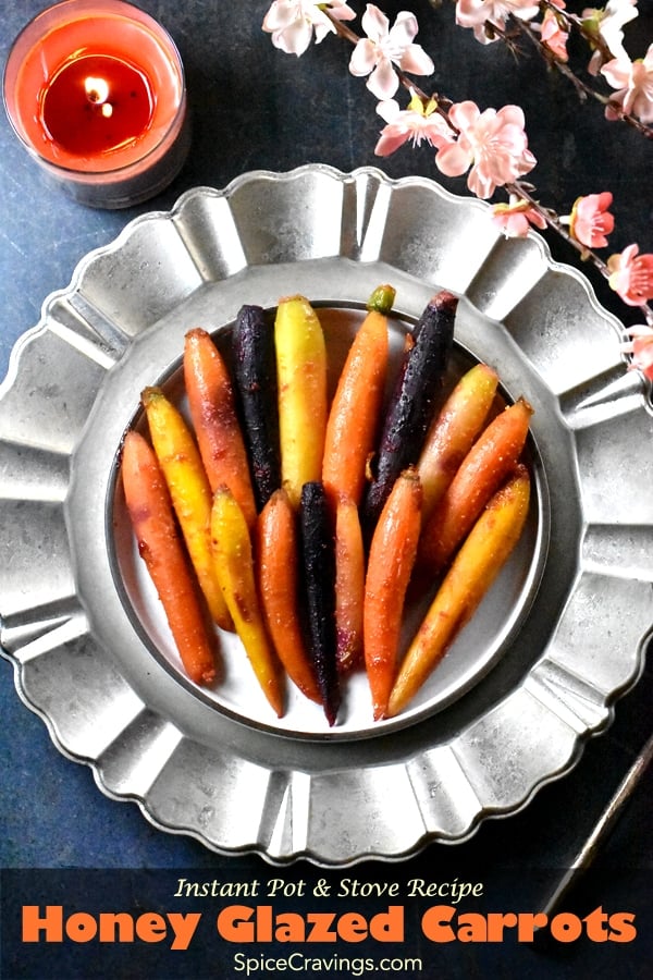 Citrus honey glazed carrots placed on a silver charger plate