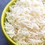 A lime green bowl of fluffy and perfect white rice cooked in Instant pot