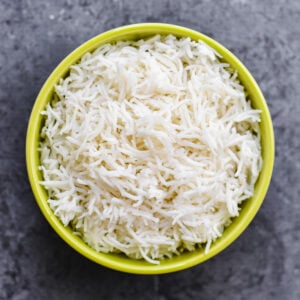 A green bowl of white fluffy basmati rice