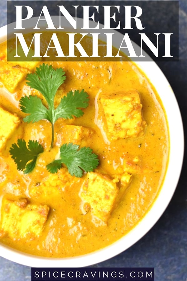 Creamy paneer butter masala garnished with a sprig of cilantro
