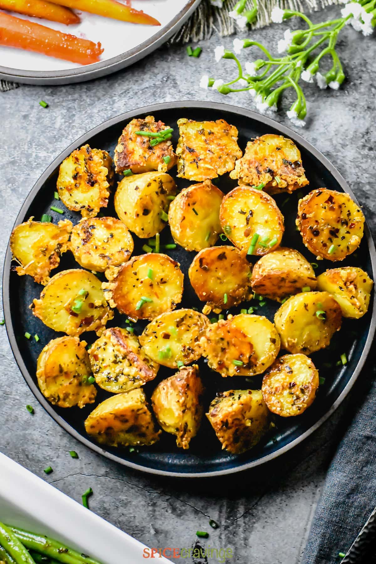 Crisp baby potatoes crusted with herbs and cheese