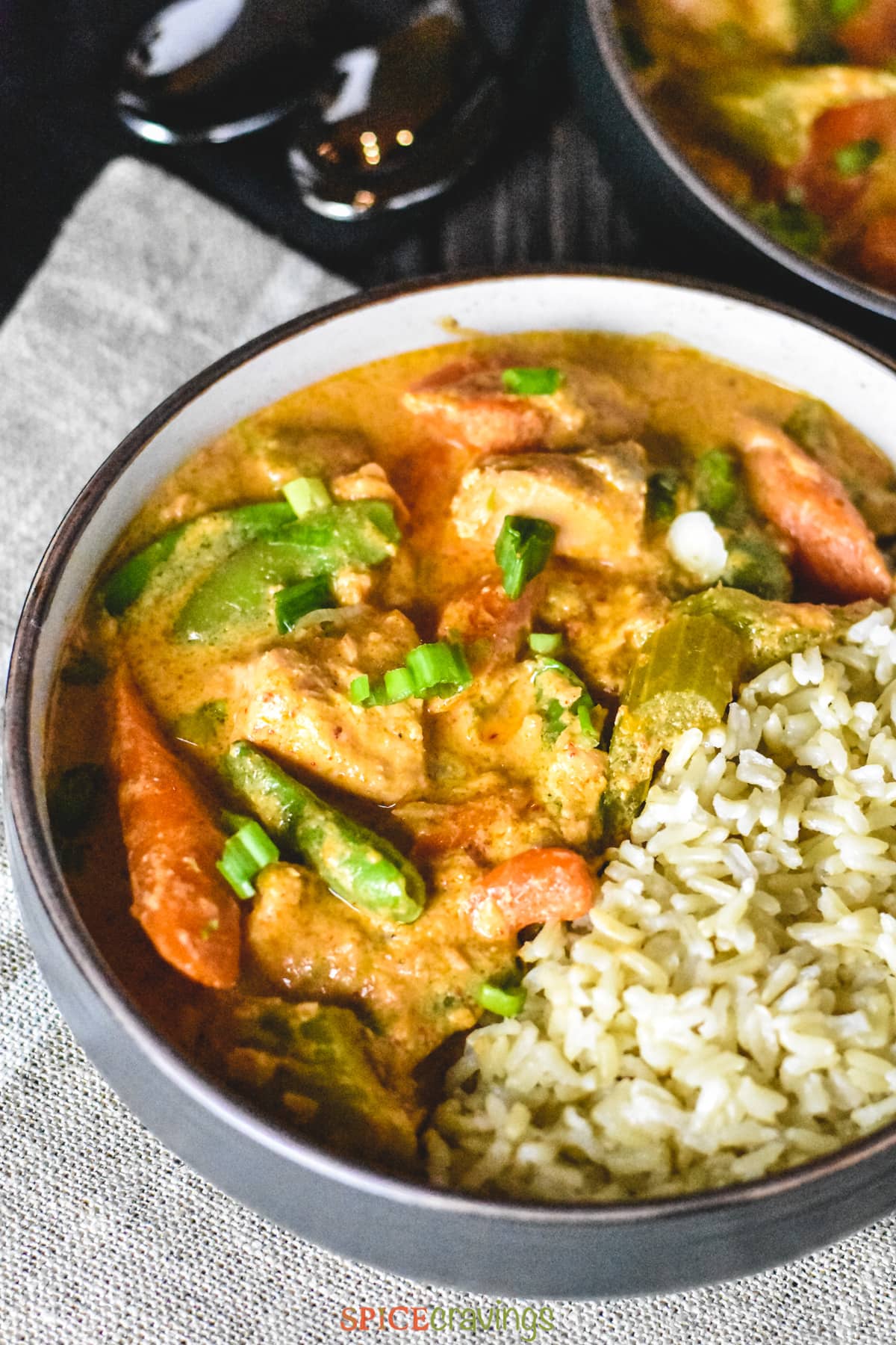 Salmon chunks cooked in coconut milk and red curry paste with crunchy vegetables like celery, carrots and snap peas, and served with brown jasmine rice