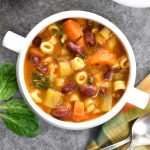 A big bowl of Pasta fagioli Soup with red beans, pasta, celery and carrots