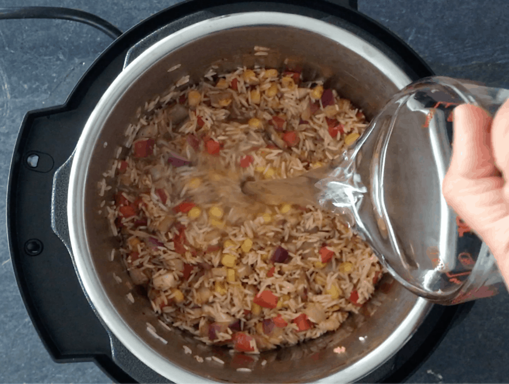 Adding water to the Instant pot to make Mexican Rice