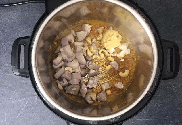 Sauteing aromatics and cashews to make chicken tikka masala