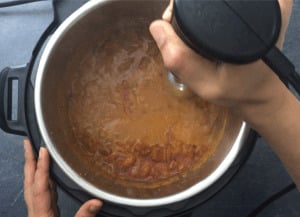 Pureeing the chicken tikka masala sauce with a hand blender