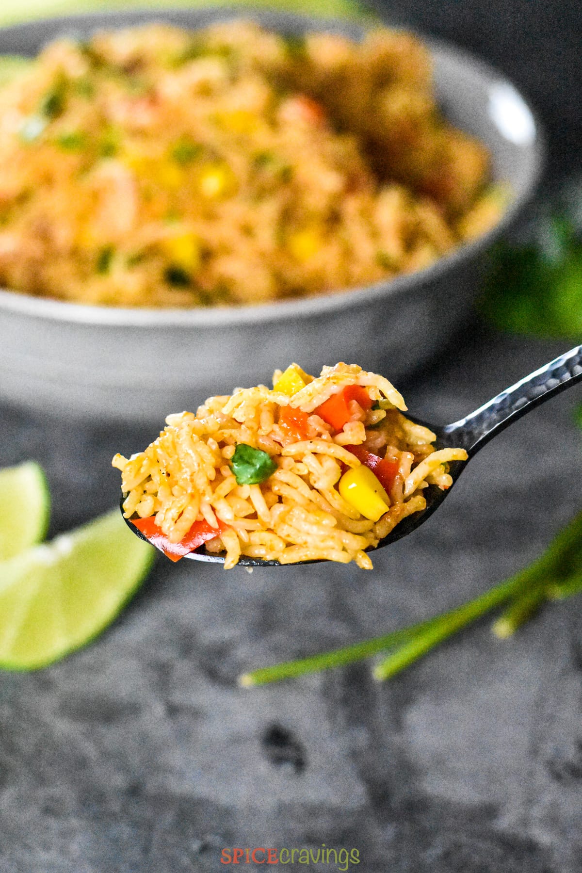 A spoonful of fluffy and colorful Mexican rice