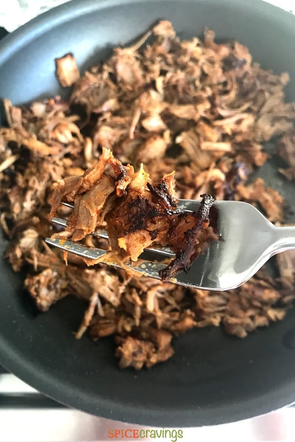 Crisping shredded pork in a skillet for carnitas