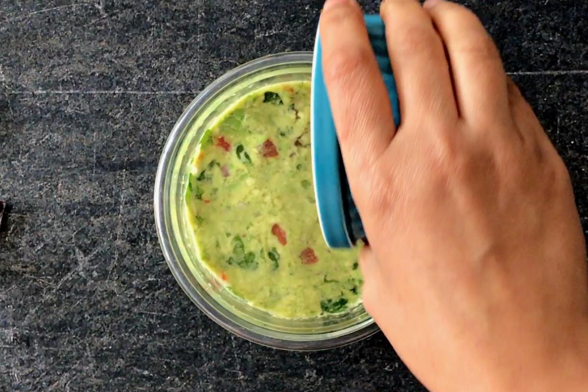 Adding water to cover the surface of guacamole