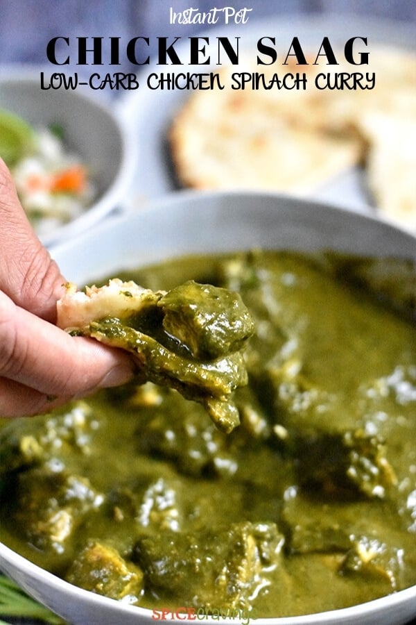 Scooping chicken saag with naan