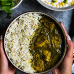 A bowl of chicken Saag curry served with basmati rice
