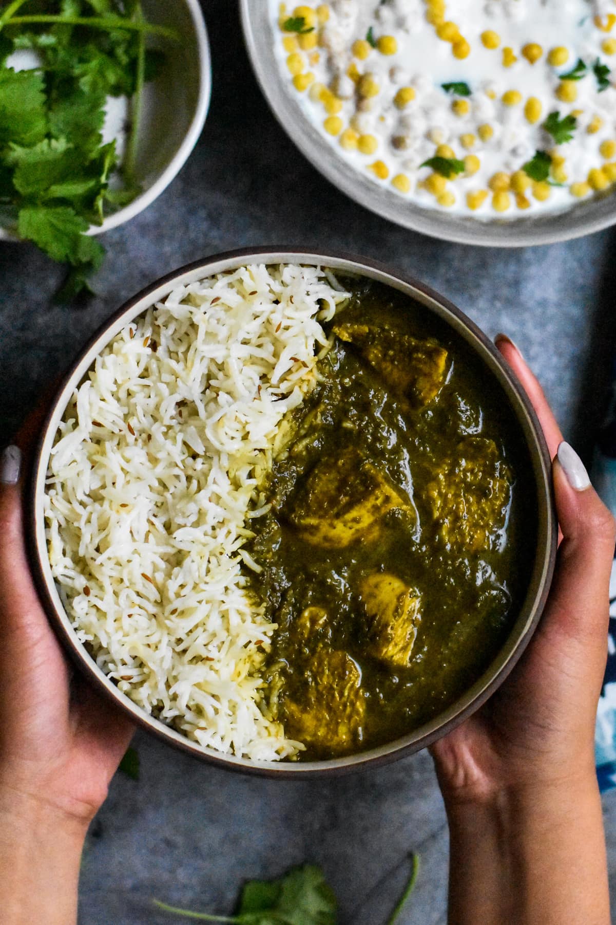 A bowl of chicken Saag curry served with basmati rice