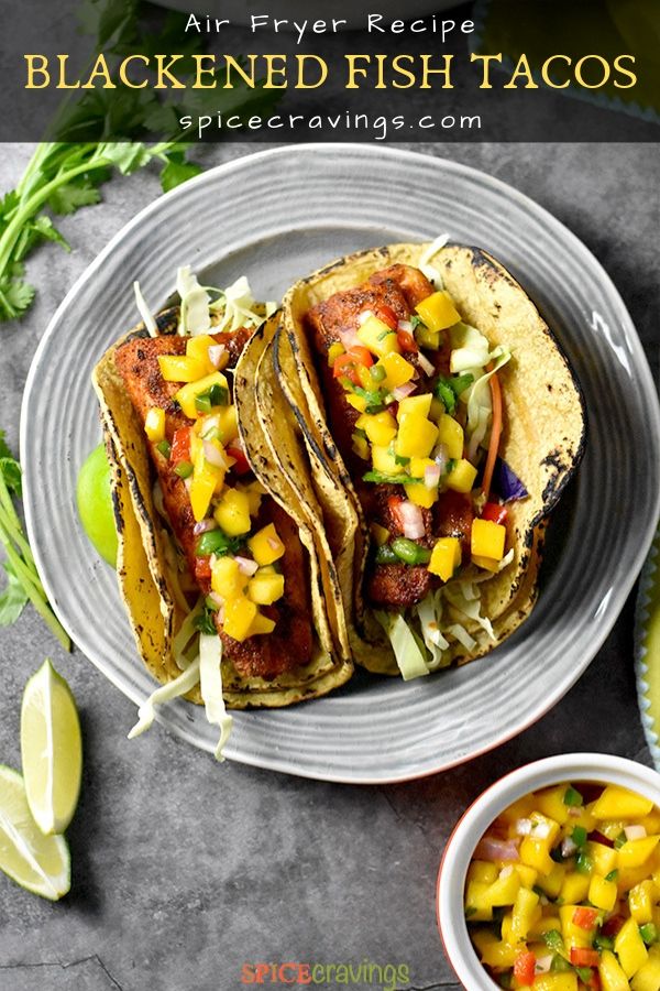 Two Fish Tacos garnished with mango salsa