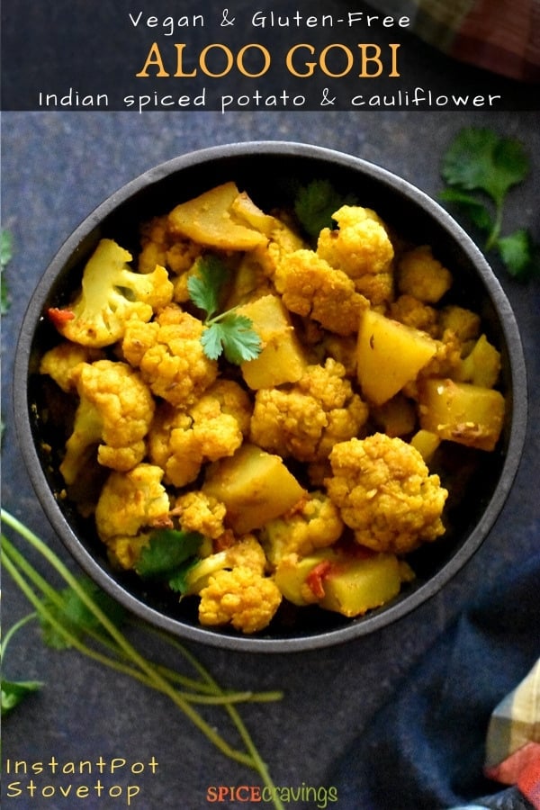 Indian spiced potato and cauliflower served in a black bowl