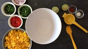 ingredients needed to mango salsa on a cutting board